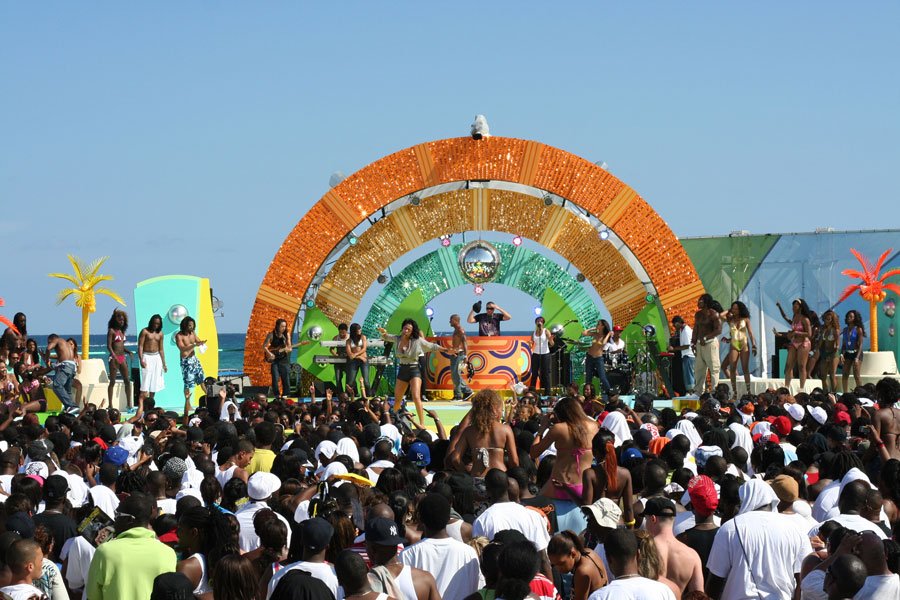 Live concert at full production scale with massive beachfront audience