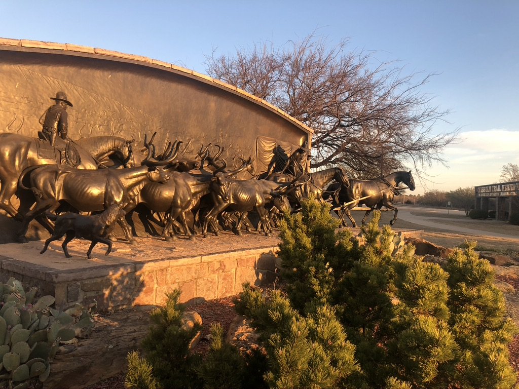 Paul Moore's On the Chisholm Trail monumental bronze sculpture at golden hour
